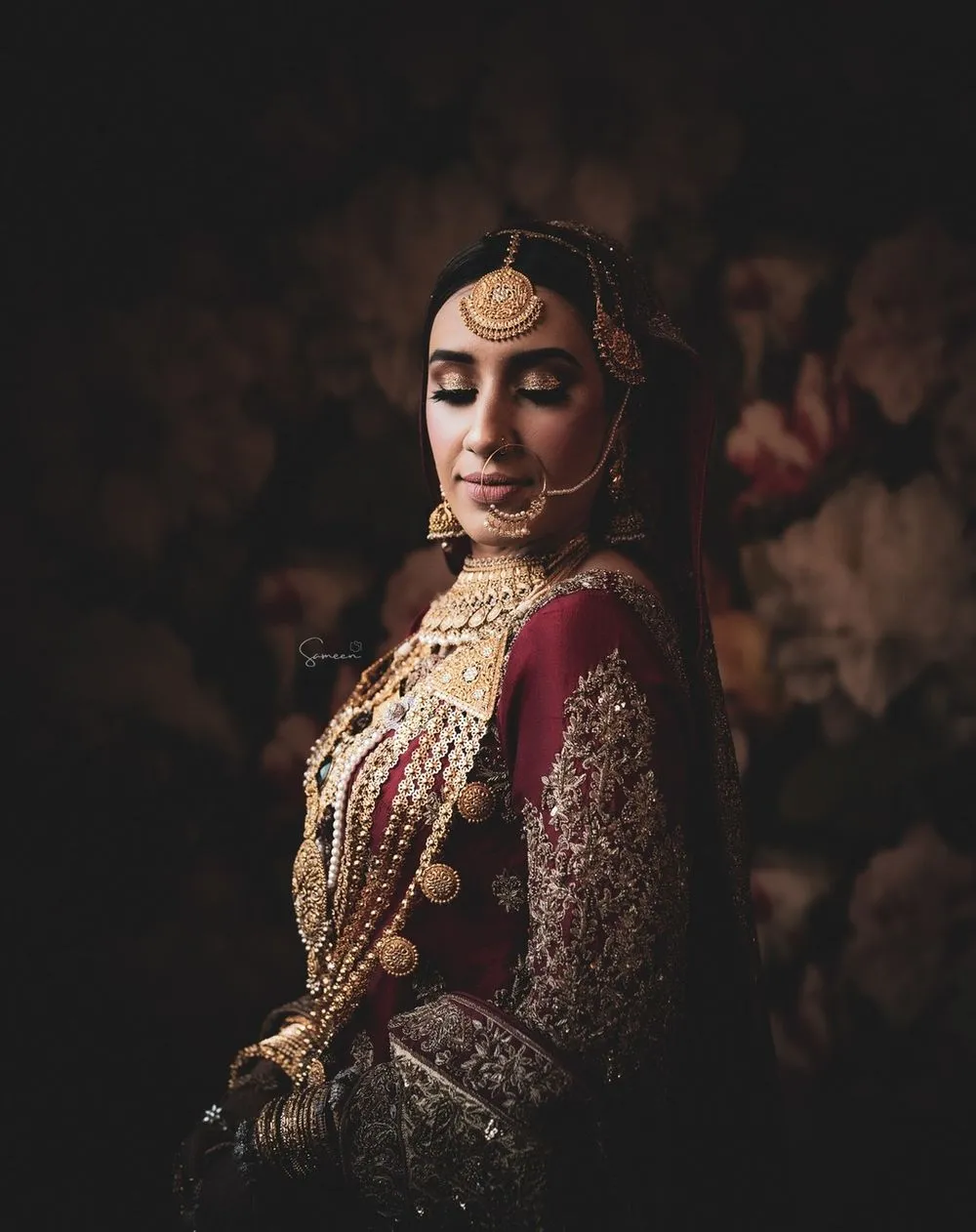 Bride in a red lehenga and gold jewelry