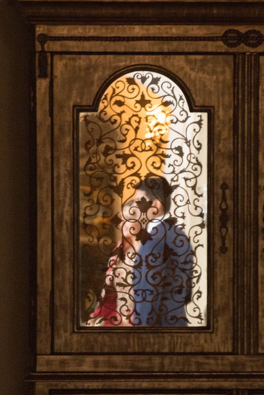 Couple framed by a carved wooden doorway